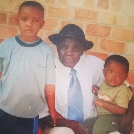 Darwin Chapuswike, his brother, and grandfather Peter K. Chapuswike in Chingola, Zambia, June 2003