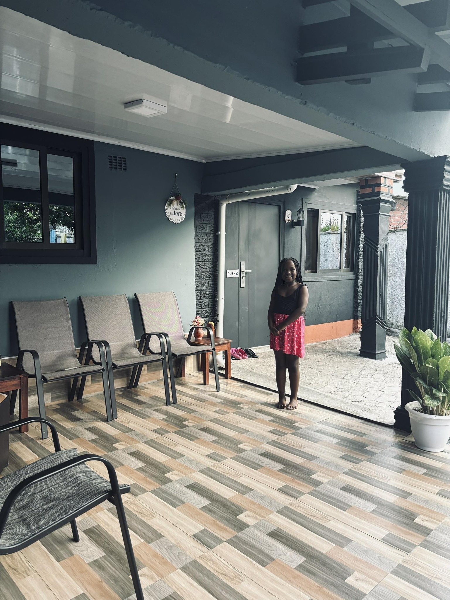 Matanda standing on a veranda in Chingola, Zambia, April 2025